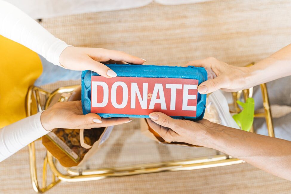Hands holding a donation box labeled “Donate,” symbolizing nonprofit donor engagement and charitable giving.